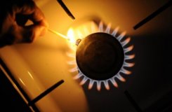 A man lights a gas stove on January 6, 2009. Husbands who spend more time doing traditionally female chores -- such as cooking, cleaning, and shopping -- reported having less sex than those who do more masculine tasks, according to a study in the American Sociological Review.