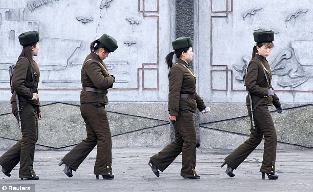 Femme fatales: Female North Korean soldiers patrol along the banks of Yalu River, near the town of Sinuiju, as the world remained on high alert for a North Korean missile launch