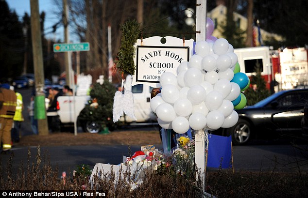 Balloons, candles, flower, signs and stuffed toys make up part of the makeshift memorial outside a firehouse which was used as a staging area for families following the mass shooting