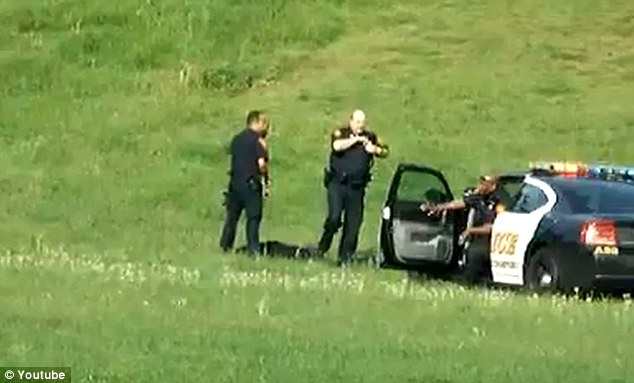 Attack: A third officer drives up in a police cruiser with the sirens blaring and joins in with the beating
