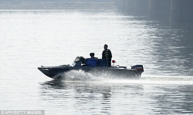 Keeping watch: A North Korean patrol boat cruises the Yalu River after a key border crossing between North Korea and China was closed to tourist groups as nuclear tensions mounted