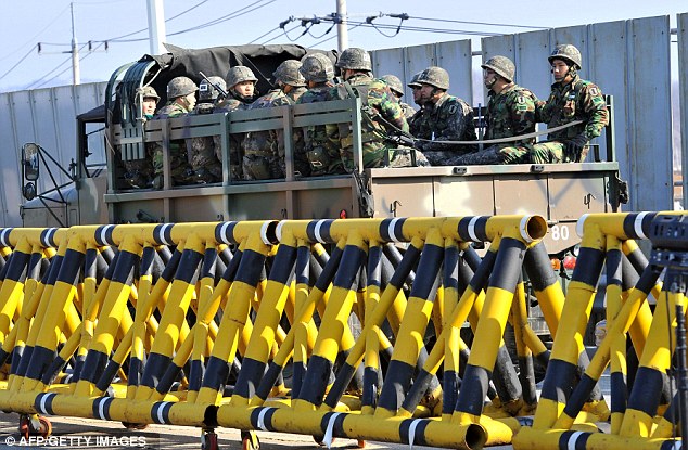 Mobilising: South Korean soldiers ride a military truck on the road leading to North Korea at a military checkpoint in the border city of Paju