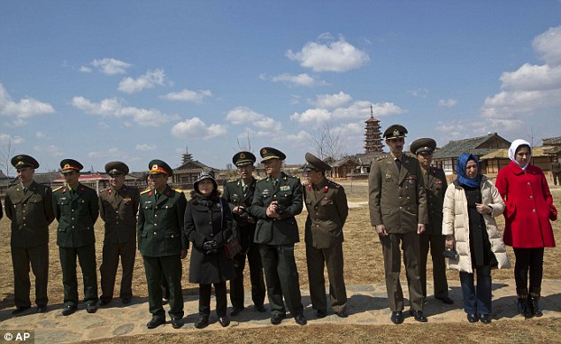 Still finding time to relax: North Korean military, along with foreign military attaches from Russia, China, and Iran watch a dance performance as they visit the Pyongyang Folk Park on the outskirts of the capital