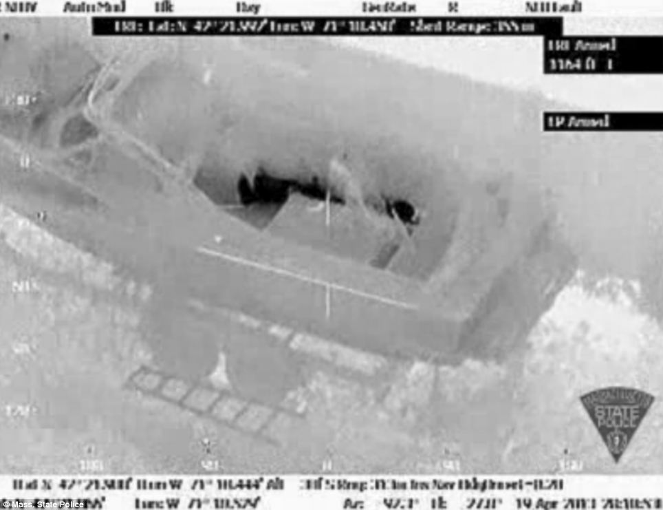 Concealed: The suspect appears to be laying flat in the boat in the final moments before his capture