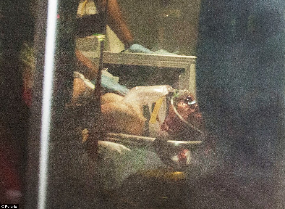 Wounded: Dzhokhar Tsarnaev was immediately loaded into an ambulance and rushed to the hospital, where he remains in serious condition