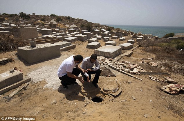 Tthe head of the Islamic Movement in Jaffa, Sheikh Mohammed Najem (right) looking at the hole that was made above the mass grave 