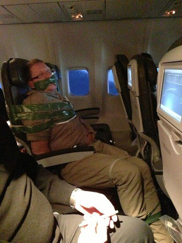 Passenger drank all of his duty free liquor on the flight from Iceland to JFK yesterday. When he became unruly, (i.e. trying to choke the woman next to him and screaming the plane was going to crash), fellow passengers subdued him and tie him up for the rest of the flight. He was escorted off the flight by police when it landed