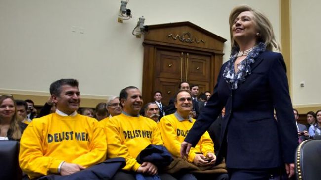 US Secretary of State Hilary Clinton walks past the members of the terrorist MKO group (file photo).