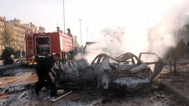 A man is seen at the site of an explosion at Aleppo University in Syria, January 15, 2013.