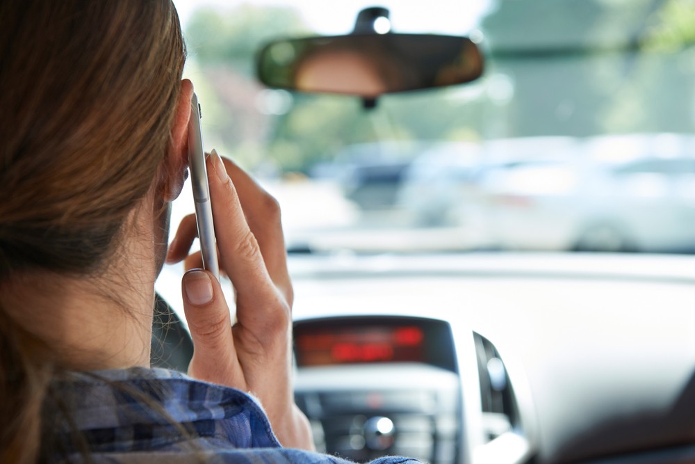 The increase in accidents among cell phone users may be caused by the flood of calcium ions into brain cells. Via: SpeedKingz | Shutterstock.